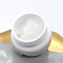 Load image into Gallery viewer, Tack free gel to make 4D/5D or raised elements. This product is clear with a very fine glitter that reflects a blue green shift. Can be mixed with other colors for different effects. Mold with a brush or silicone tool moistened with alcohol or water. Designs made with Carved Glitter Gel and Gem & Charm Gel. Try displaying your designs on one of our cute mixing palettes!