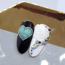 Load image into Gallery viewer, Tack free gel to make 4D/5D or raised elements. This product is clear with a very fine glitter that reflects a blue green shift. Can be mixed with other colors for different effects. Mold with a brush or silicone tool moistened with alcohol or water. Designs made with Carved Glitter Gel and Gem & Charm Gel. Try displaying your designs on one of our cute mixing palettes!